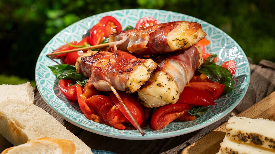 Grilled Gretiki Cheese Wrapped in Bacon with Roasted Pepper and Tomato Salad